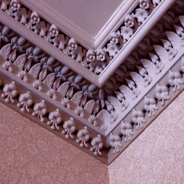 Interior cornices of History House. The cornices feature a floral design.