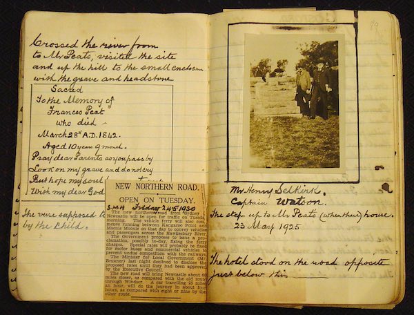 Photograph of Watson's 'Excursion Journal'. Beside handwritten notes is a photograph of two men standing beside some steps, and a newspaper article has been glued into the journal.