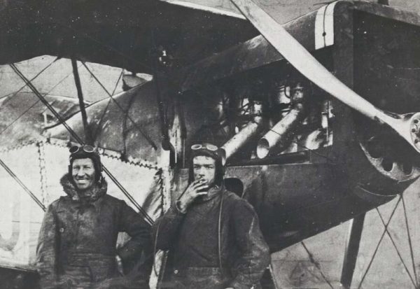 Sir Charles Kingsford Smith and Charles Ulm standing next to their plane after arrival in England 1929.