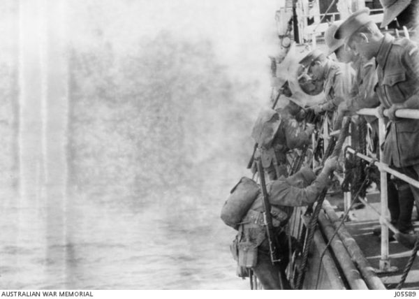 Soldiers of the First AIF disembark the troop ship on rope ladders for the landing at Anzac Cove