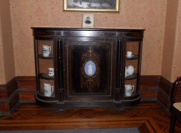 Photograph of Margaret Doak’s middle class sideboard donated to History House in 1953. On the top of the sideboard is a photograph of a smart – looking woman. Identified as May Jane (Minnie) Beattie second owner of the sideboard.