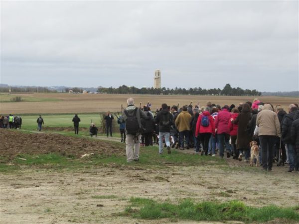 Picture of a group of people walking to the memorial for bushfire awareness.