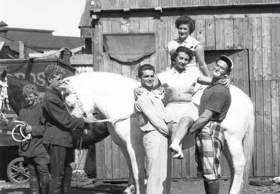 Black and white photo of the St Leon Family riding a horse. Peggy St Leon held by brothers Leo and Joe, sister Stella behind on the horse.