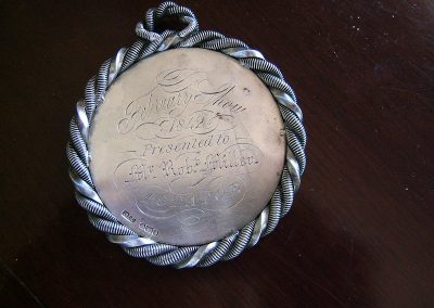 A silver medal engraved with the words 'February Show. 1842. Presented to Mr Robt. Miller. Potatoe'.