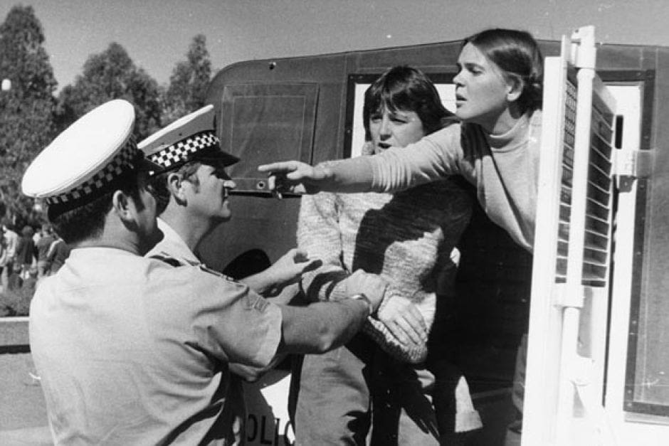 A protester in the Women Against Rape in War demonstration on Anzac Parade, Sydney, 25 April 1981, demanding to know the number of the arresting constable.
