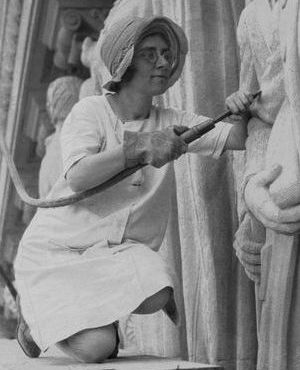 Photograph of Daphne Mayo working on her sculpture on the Brisbane City Hall tympanum in 1930.