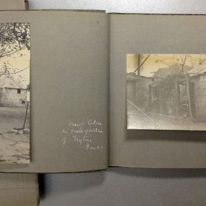 Photo albums featuring black and white photographs of buildings.