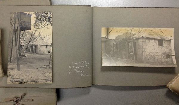 Photo albums featuring black and white photographs of buildings.