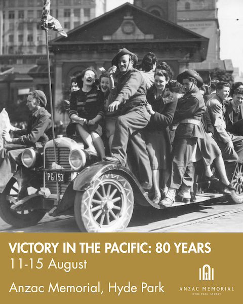 Australian soldiers celebrate the end of the war in the Pacific with ladies. They are hanging on the side of a car.