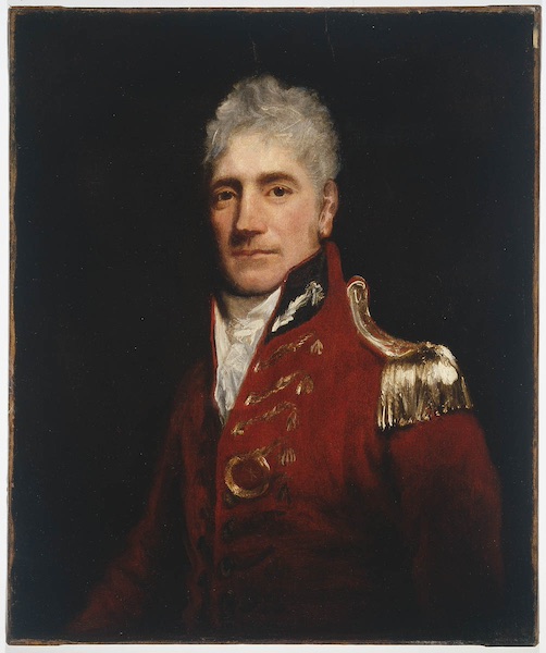 A portrait attributed to Lachlan Macquarie in 1805. He is dressed in red military attire, with gold tassels and gold embroidery, and a cravat.