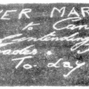 Photograph of chalk writing on pavement taken from the Mirror newspaper in Perth in 1930. The text reads: 'HUNGER MARCH. Perth to Canberra. 2.30 Today.'