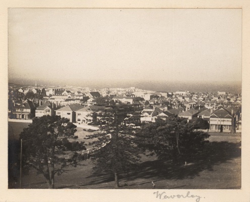 View looking east from an elevated position above the oval in Waverley Park. Park Parade with its flats and houses can be seen running along the eastern edge of the park. The tall sewerage ventilation tower on Military Road Bondi, a prominent landmark on the escarpment, can be seen to the north east.
