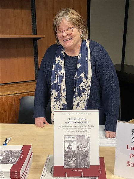 Dr E. Jeanne Harris poses with her new book titled 'Cleanliness is Next to Godliness'.