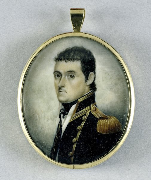 A miniature watercolour portrait of Matthew Flinders. He is dressed in a blue naval coat with gold tassels and buttons.
