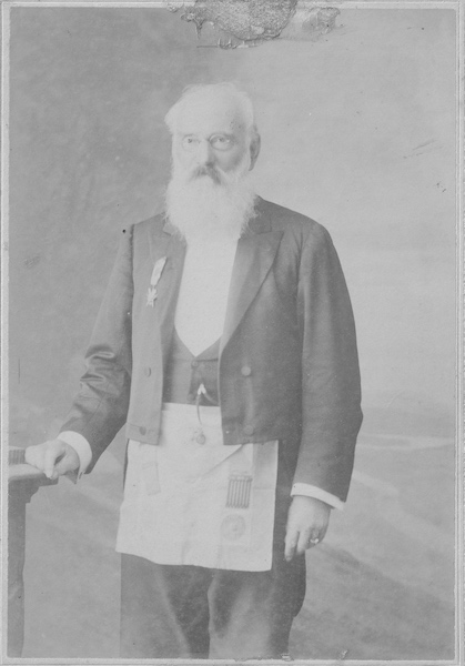 A portrait-style photograph of William Waterhouse, wearing a black suit with a Freemason apron.