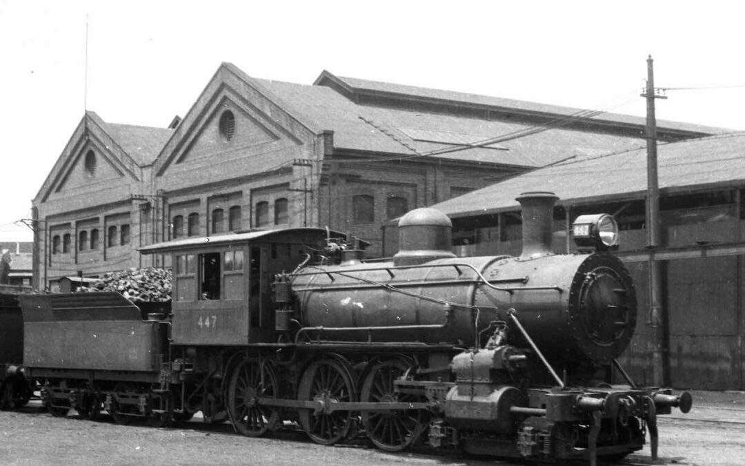 NSW Government Railway Class O-446 steam train on tracks outside Eveleigh Locomotive Workshops.