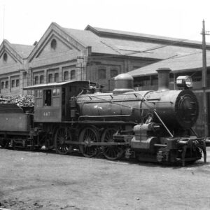 NSW Government Railway Class O-446 steam train on tracks outside Eveleigh Locomotive Workshops.