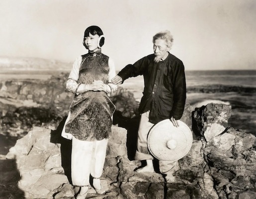 A screenshot of the film 'Toll of the Sea', featuring actor Anna May Wong dressed in traditional Asian attire.