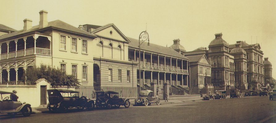 Parliament House with a variety of 1920s cars parked in front.