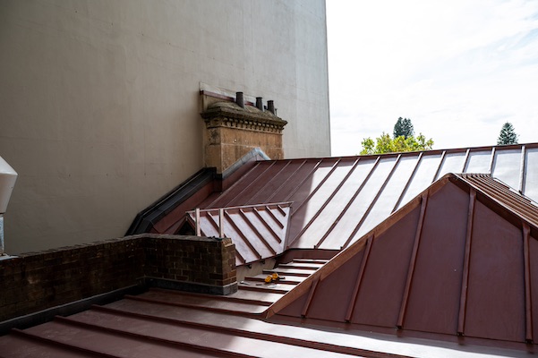 Photograph of History House's brick parapet chimney and new iron roof